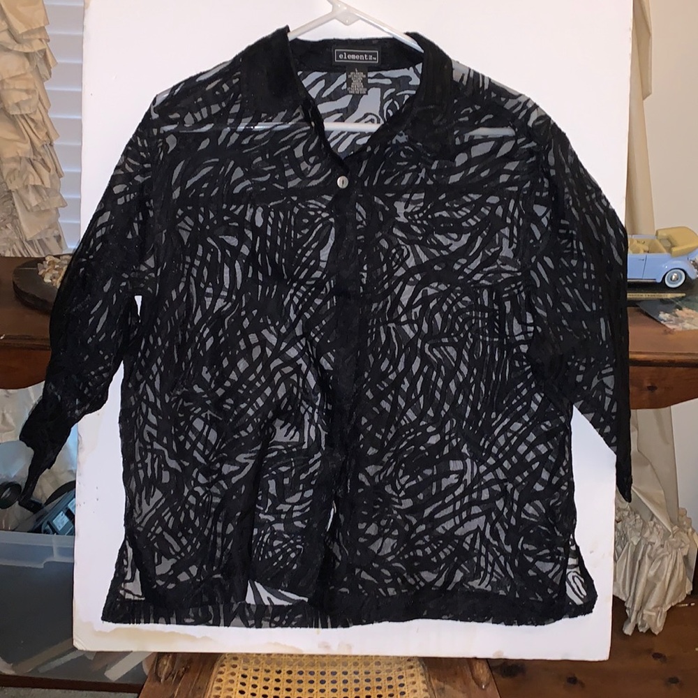 Elemenz ladies blouse. Large floral type see thru print. Black and sheer.